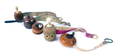 A group of 19thC and later tape measures, to include a measure modelled as a butter churn, 2.3cm diameter, a boxwood measure, barrel shaped measure with Stanhope viewer, another similar, and a miniature copper pan measure.