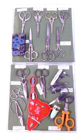 A group of sewing scissors, varying designs to include stork, a buttonhole cutter, cleaper, etc.