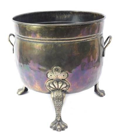 A late Victorian copper and brass two handled log bucket, the copper body of cylindrical form, raised on three brass lion paw feet, 36cm high, 35.5cm diameter.