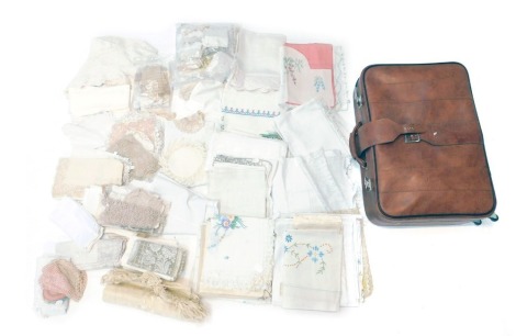 Various vintage linen and lace, to include, lace offcuts, worked cloths, napkins, etc., contained in a suitcase.