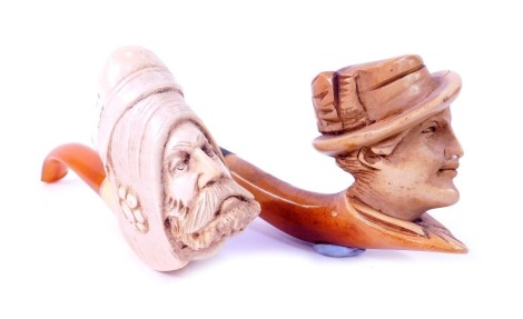 Two meerschaum pipes, one decorated with the head of a Middle Eastern gentleman with amber cheroot, 13cm long, the other with figure of a gentleman in hat, 14cm long.