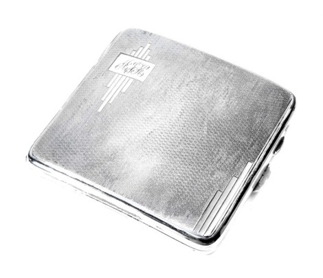 An Edward VII silver cigarette case, of ached form with engine turned engraved decoration, with Art Deco style panel bearing the initial AJH, Birmingham 1939, 3.65oz.