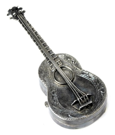 A novelty guitar pill box, formed in the shape of a guitar, the base opening, white metal, London 1993, with import marks, 8.5cm high, 0.57oz.