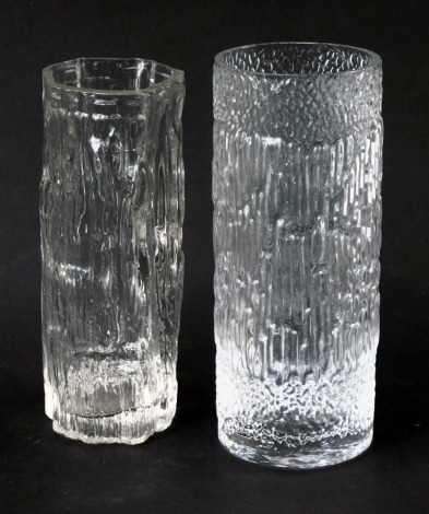 A Whitefriars style clear glass vase, of cylindrical form, with moulded bark style decoration, 22cm high, and another similar, 21cm high. (2)