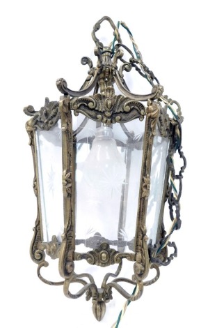 A 20thC brass framed ceiling light, of hexagonal form, with clear glass panels, etched with star motifs, the frame cast with scrolls and roundels, etc., 42cm high. WARNING! This lot contains untested or unsafe electrical items. It is supplied for scrap o