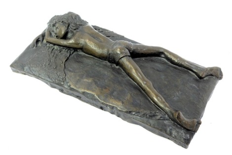 Stephen Coote. Cast bronzed resin figure of a young boy, lying down on naturalistic base, unsigned, 40cm x 18cm.