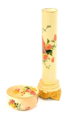 A Royal Worcester blush porcelain trinket box and cover, of cylindrical form, decorated with flowers, printed marks, 7cm diameter, together with a cylindrical vase, decorated with flowers, gilt heightened, printed marks, No 713, 19cm high.