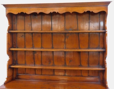 An oak Welsh dresser in 18thC style, the top with a moulded edge with three shelves, the base with three moulded drawers with turned handles, above a central small drawer flanked by two panelled cupboards, on stiles, 200cm high, 152cm wide, 51cm deep. - 3