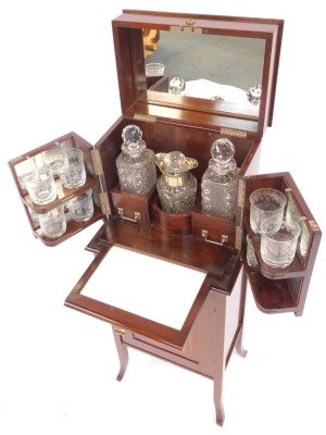 An Edwardian mahogany drinks cabinet, the hinged inlaid top with a moulded edge opening to reveal three recesses containing three cut glass decanters with lower drawer to each section, mirror to underside of lid, two hinged doors to front of cabinet conta - 2