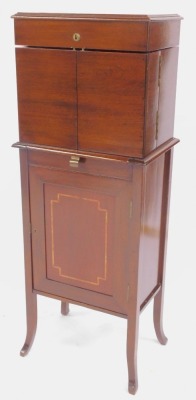 An Edwardian mahogany drinks cabinet, the hinged inlaid top with a moulded edge opening to reveal three recesses containing three cut glass decanters with lower drawer to each section, mirror to underside of lid, two hinged doors to front of cabinet conta - 4