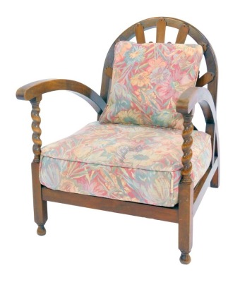 An early 20thC beech and walnut child's chair, with curved back inset with a pierced sunburst back, curved arms and barley twist supports, floral upholstered removable seat and cushion, on square legs, on rounded feet.