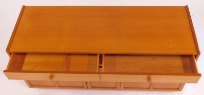 A Nathan teak side cabinet, the rectangular top above an arrangement of four drawers, the base of two panelled cupboard doors, on plinth base, 75cm high, 102.5cm wide, 46cm deep, together with another similar cabinet, the top with two drawers above a cent - 3