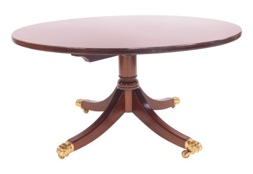 A 20thC mahogany coffee table by Deryck Gilham of Long Sutton Lincolnshire, the circular top with boxwood line inlay, on a cylindrical turned column raised on outswpet legs capped by lion paw feet, on castors, 56.5cm high, the top 106cm diameter.