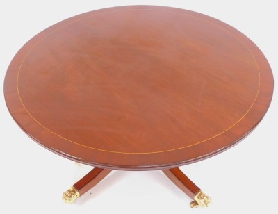 A 20thC mahogany coffee table by Deryck Gilham of Long Sutton Lincolnshire, the circular top with boxwood line inlay, on a cylindrical turned column raised on outswpet legs capped by lion paw feet, on castors, 56.5cm high, the top 106cm diameter. - 2