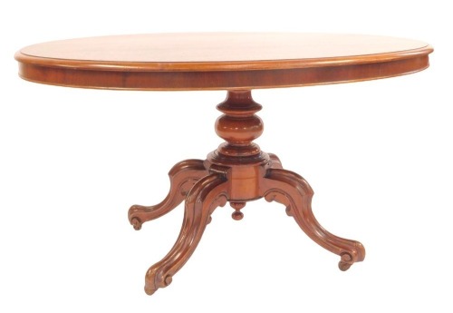 A Victorian mahogany breakfast table, the oval top with a moulded edge, raised on a turned column, on scroll carved legs, 74cm high, the top 134cm x 103cm.