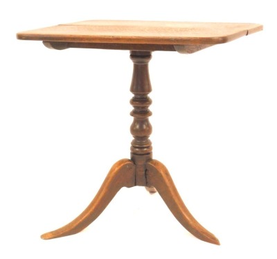 A 19thC oak tilt top table, the rectangular top with a rounded edge, on turned column terminating in three outswept legs, 73cm high, the top 52cm x 70cm.