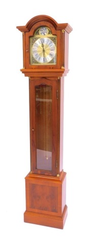 A 20thC yew cased longcase clock, the brass dial bearing silvered chapter ring, Roman numerals, brass spandrels, weight driven, central door with glass panel with pendulum and weights, 187cm high.