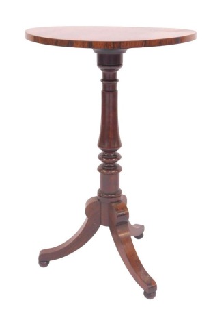 A 19thC rosewood tripod table, the circular top on a turned column, raised on three sabre legs, 73cm high, the top 47.5cm diameter.