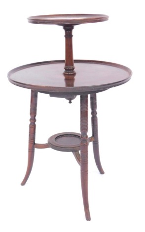 A Victorian mahogany two tier dumb waiter, two associated graduated circular sections with a dished top united by turned column, on turned cylindrical out splayed legs united by an under tier, 91cm high, 62cm diameter.