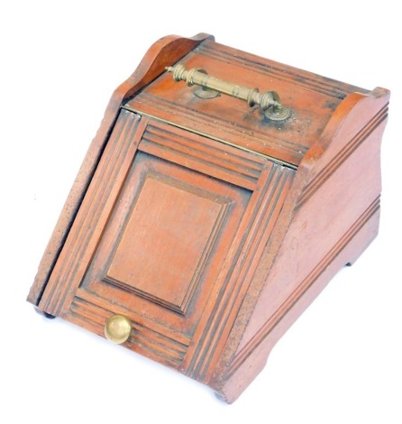 A late Victorian/early Edwardian oak coal scuttle, with brass handle and fielded panelled door, 32cm high, 36cm wide, 52cm deep.