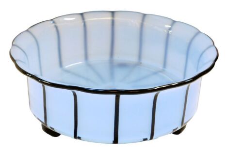 A Michael Powolny for Loetz blue opaque glass bowl, with an everted black rim and multiple black vertical stripes, on three ball feet, 9cm high, 21.3cm diameter.