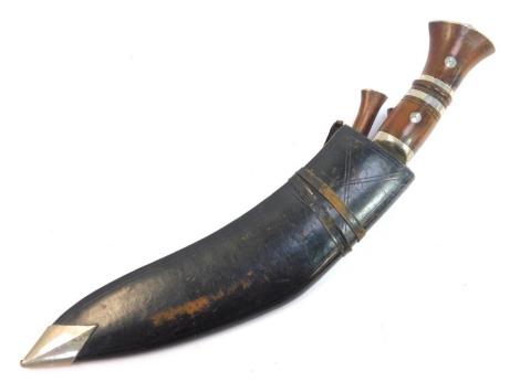 A Nepalese or Indian Kukri, with wooden handle, curved steel blade, together with the karda and chakmak knives, in black leather scabbard, length of blade 29.5cm.