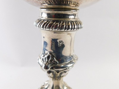 A pair of George III silver candlesticks, each with shell capped hexagonal scrolling base, on a reeded stem, London 1767 by Ebenezer Coker, 45.78oz, 27cm high. (2) - 3