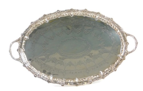 A Barraclough & Sons of Leeds Victorian silver galleried serving tray, with shell reeded handles, and engine engraved bright cut floral detail, Sheffield 1891, 52cm wide, 73.9ozt.