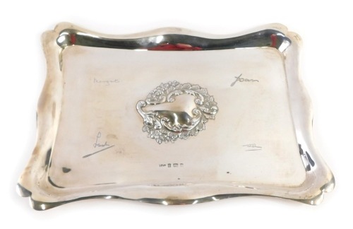 A Edward VII silver embossed serving tray, rectangular form with a fluted border, central vacant cartouche with fern and flower spray, bearing signatures Margaret, Jack, John and Joan, 30cm x 22cm, Birmingham 1906, 15.72oz.