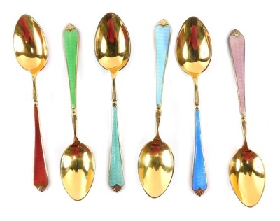 A cased set of six George V silver gilt enamel teaspoons, with red, green, teal, light blue, dark blue, and pink enamel detail, Birmingham 1934, 2.21oz, in fitted case.