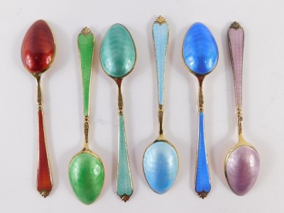 A cased set of six George V silver gilt enamel teaspoons, with red, green, teal, light blue, dark blue, and pink enamel detail, Birmingham 1934, 2.21oz, in fitted case. - 2