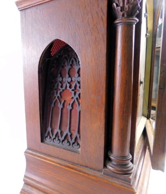 A Victorian gothic bracket clock, the oak case decorated with scrolls, pillars, and leaf carved finials, the arched dial with slow/fast, charm/silent, full chime/Westminster chime subsidiary dials, surrounding a Roman numeric dial with engraved spandrels, - 3