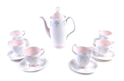 A Royal Albert Magic Moments pattern part coffee service, to include five cups, six saucers, milk jug, coffee pot with printed design of flowers, on a cream ground with pink highlights.