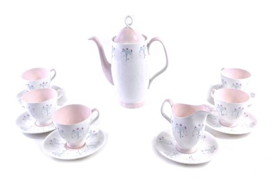 A Royal Albert Magic Moments pattern part coffee service, to include five cups, six saucers, milk jug, coffee pot with printed design of flowers, on a cream ground with pink highlights.