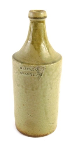 A 19thC pale stoneware bottle stamped West & Co Grantham, 24cm high. (AF)