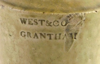 A 19thC pale stoneware bottle stamped West & Co Grantham, 24cm high. (AF) - 2