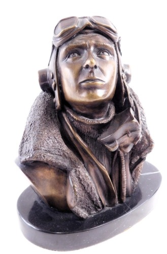 A bronzed Aviation figure, on an oval black marble base, depicting aeroplane pilot, 21cm high, stamped BS.