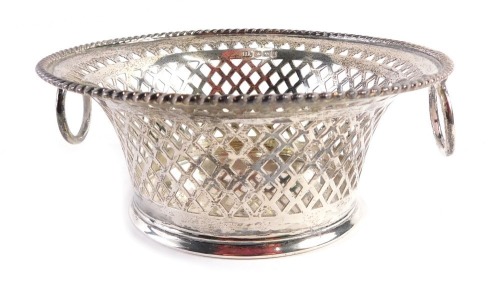 An Edward VII silver sugar basket, with a circular reeded border, and pierced bow basket design, with two swing handles, maker HA, Sheffield 1908, 12.5cm diameter, 5.13oz.