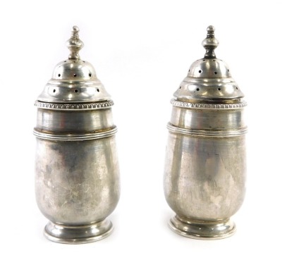 A pair of George V Walker and Hall silver pepperettes, each with a pierced top, Birmingham 1920, 2.82oz. (2)