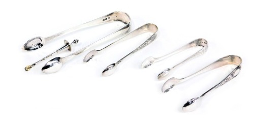 A group of silver and silver plated cutlery, comprising a pair of Victorian silver sugar nips of plain design, 1.23oz, three pairs of silver plated sugar nips, and a silver preserve spoon with lid top to fit in a jar, 0.27oz. (5)