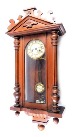 A Gustav Becker Vienna wall clock, with arched crest, glazed door, flanked by reeded pilasters, above turned finials, 84cm high.