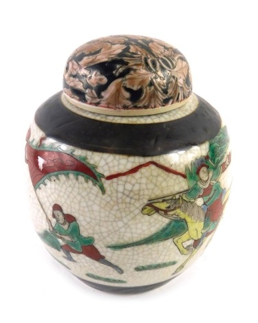 A late Chinese porcelain ginger jar, decorated with figures, flags, etc., on a crackle ground, with associated lid, 15cm high.