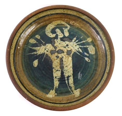 A John Davey studio pottery bowl, decorated with a stylised figure, on a blue ground, impressed mark to underside, 33cm diameter.