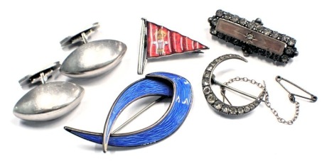 A group of silver jewellery, comprising a pair of Danish oval shaped cufflinks, each stamped sterling, a silver and paste stone set crescent moon brooch on single pin back with safety chain, 2.5cm wide, a Norwegian silver and enamel brooch with crossover 