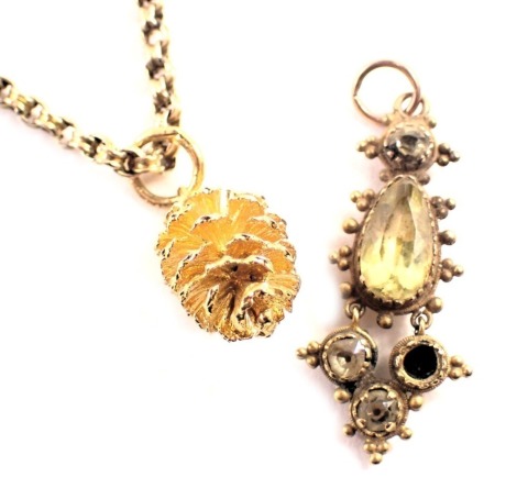 An Edwardian style pendant, set with imitation citrines, in a rub over brass setting, a pine cone pendant, and a partial yellow metal chain, possibly 9ct, unmarked, 3.2g. (3)