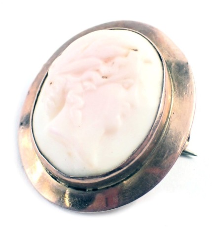 A 20thC shell cameo brooch, the oval cameo depicting maiden with flowing hair, in a rub over rose gold coloured setting, stamped 9ct, 2.5cm x 3cm, 4.6g all in.