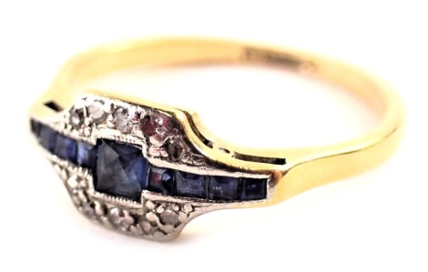 An Art Deco sapphire and diamond dress ring, the central sapphire panel set with square and rectangular cut stones, the border in platinum with tiny diamonds, on a yellow metal band stamped 18ct plat, ring size O, 2.5g all in.