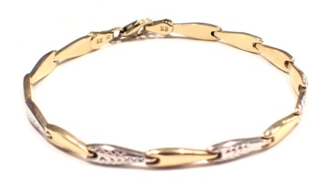 A bicolour bracelet, the diamond shaped lozenges, to include yellow metal, white gold patterned, yellow metal stamped 9kt, 18cm long, 3.4g.