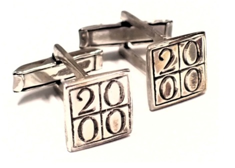 A pair of silver millennium cufflinks, each with a square cuff link head, marked 2000, 9.1g all in, boxed.