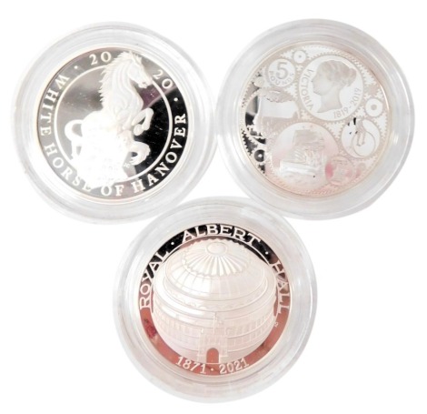 Three Royal Mint silver proof coins, comprising The Queen's Beasts The White Horse of Hanover 2020 UK one ounce silver proof coin, The 150th Anniversary of The Royal Albert Hall 2021 UK five pound silver proof coin, and The 200th Anniversary of The Birth 